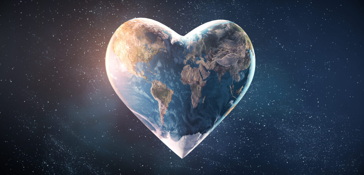 Picture from space of heart-shaped Earth with sunlight shining on the left and stars in the background.