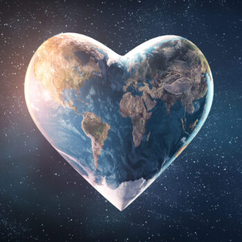 Picture from space of heart-shaped Earth with sunlight shining on the left and stars in the background.